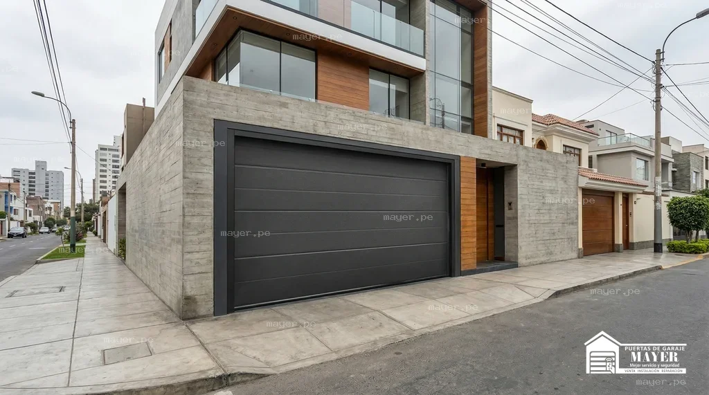 Puerta levadiza gris carbon fachada concreto
